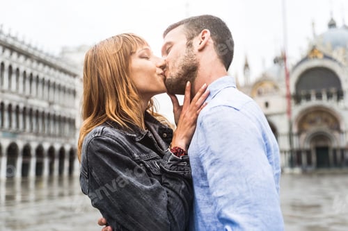 Preview: Romantic beautiful couple in love kissing in San Marco Square, Venice Italy.