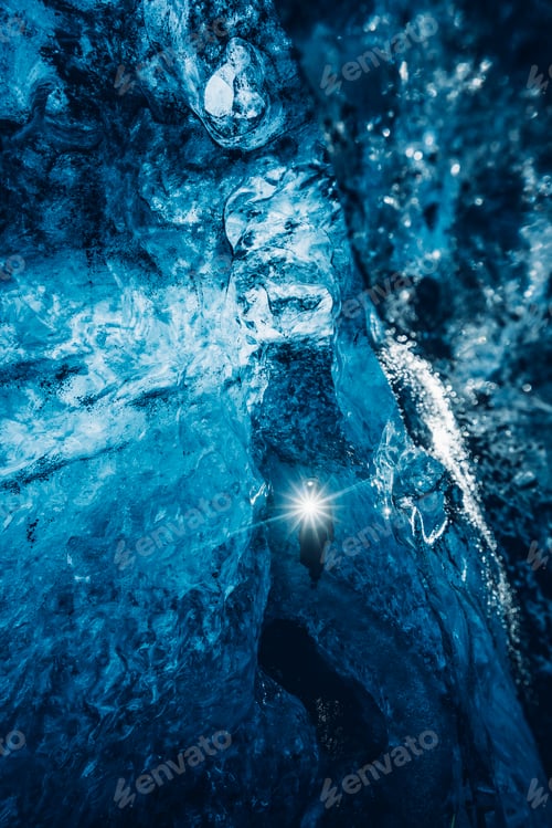 Preview: Traveler walking in blue ice cave
