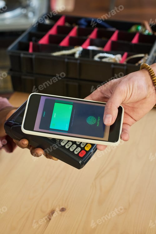 Preview: Caucasian Young Adult Hand Making Contactless Payment Using Smartphone