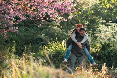 Preview: Happy couple travel nature, outdoor adventure, spring forest, cherry blossom joy