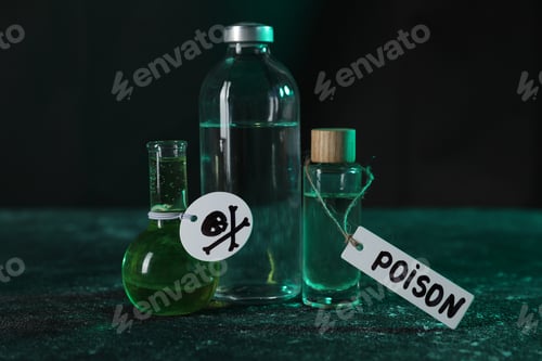 Preview: Bottles of poisons with warning sign on textured table against dark background, closeup