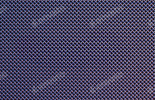 Preview: Metal grill close-up, texture of a music speaker in colored lighting.