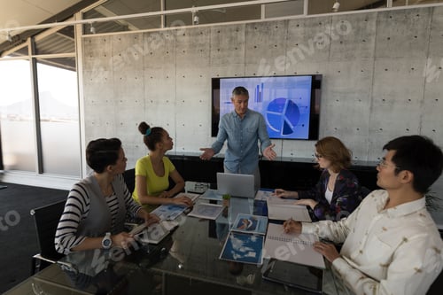 Preview: Hight view of middle-aged caucasian male executive interacting in a meeting at modern office