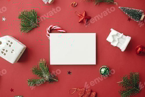 Preview: Christmas card flat lay. Modern greeting card mockup and christmas decorations and ornaments on red