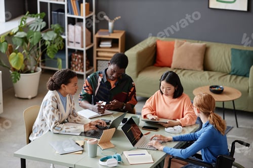 Preview: Inclusive young team enjoying work together during meeting in IT office