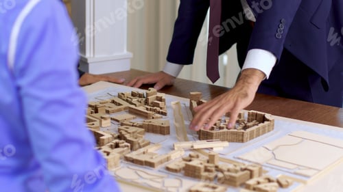 Preview: Young architect in business suit explaning his new construction project