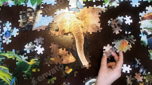 Preview: Generation z kids hand with puzzle piece to complete the elephant.