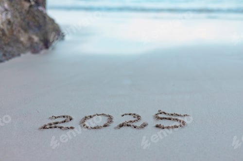 Preview: handwritten inscription 2025 on the sand by the sea