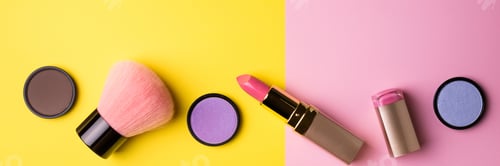 Preview: Makeup products and decorative cosmetics on color background flat lay. Fashion and beauty