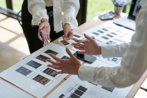 Preview: Ux designers working on mobile app wireframes in office meeting