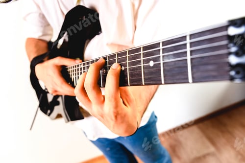 Preview: Close-up of the hands of a guitarist performing a song while pressing the strings.