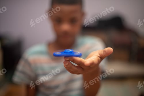 Preview: Young boy spinning fidget on his finger