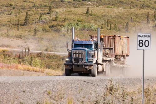 Preview: Industrial truck driving dusty rural dirt road