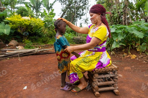 Preview: Little African girl stands in front of her albino mother who rests her hands on her head