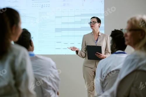 Preview: Middle Aged Woman Leading Presentation to Diverse Medical Team