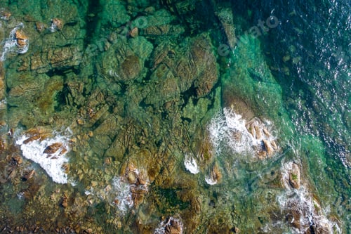 Preview: drone aerial view of a rocky shore with turquoise waters