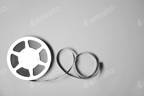 Preview: Movie reel on grey background, top view with space for text. Cinema production