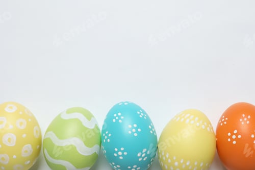Preview: Colorful painted Easter eggs on white background, top view