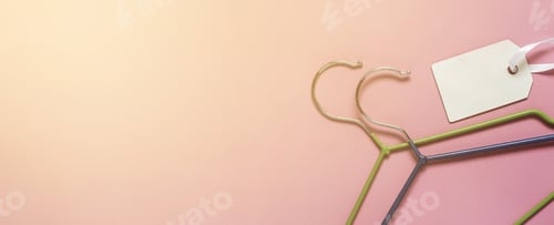 Preview: Clothing Hangers and Tag on Light Pink Backdrop