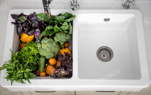 Preview: Bright washed vegetables in the kitchen sink top view.
