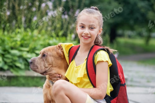 Preview: Child walking with dog. School girl after school having fun dog outdoors. Pets concept
