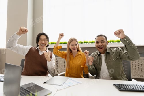 Preview: Excited business team celebrating success in the office