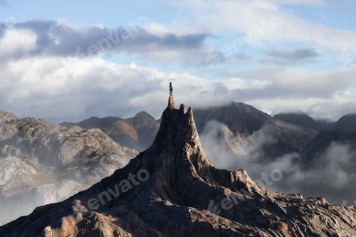 Preview: Adventurous Person Standing on top of a Rocky Mountain