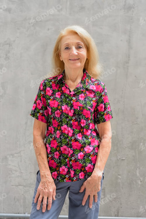 Preview: Portrait of a senior woman outdoors during summer smiling