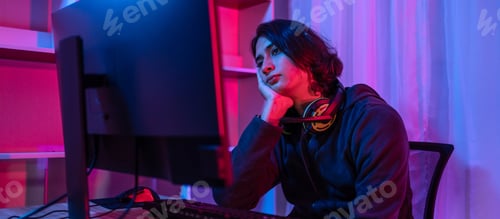 Preview: Contemplative Young Adult Stares at Computer Screen