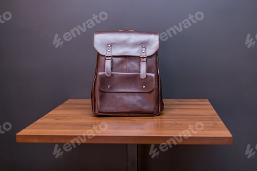 Preview: Brown leather backpacks on wood table