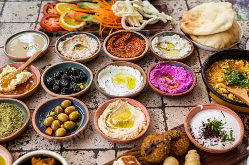 Preview: Turkish family breakfast table with pastries, vegetables, greens, spreads, cheeses, fried