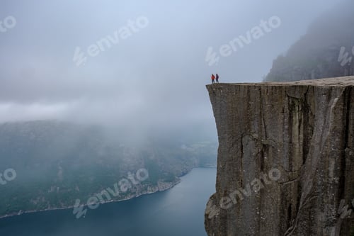 Preview: Daring Explorers Stand on Preikestolen Cliff Overlooking the Fjords of Norway