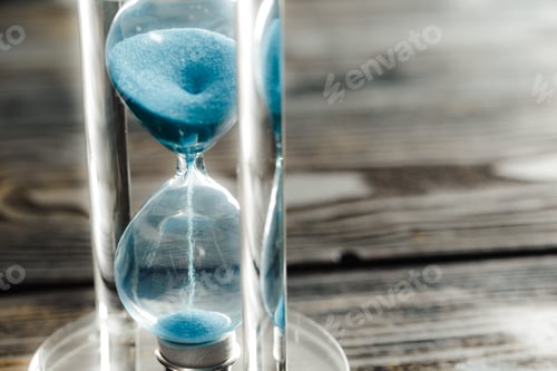 Preview: Modern hourglass on wooden background