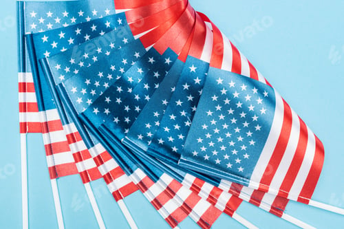 Preview: Close up View of Silk American Flags on Sticks on Blue Background