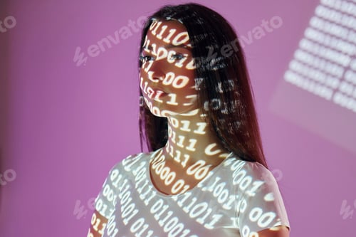 Preview: Binary machine code. Beautiful young woman is in projector neon lights in the studio