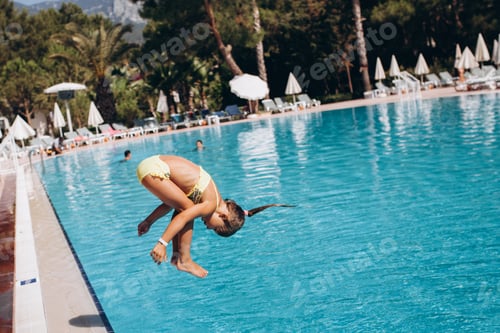 Preview: Little girl swim in the pool, jump into the water, somersault. concept of summer vacation
