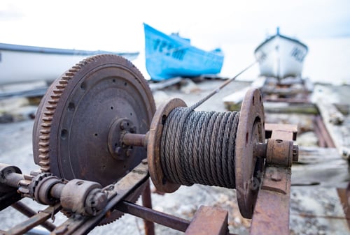 Preview: Winch with a rope on a pier with boats and boats against the sky