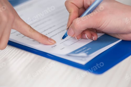 Preview: Cropped shot of doctor pointing at document and patient signing medical contract