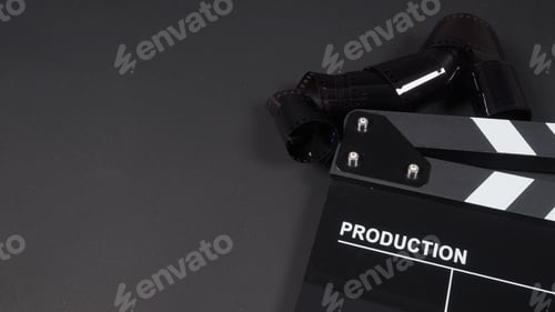 Preview: Clapper board AND films on black background.
