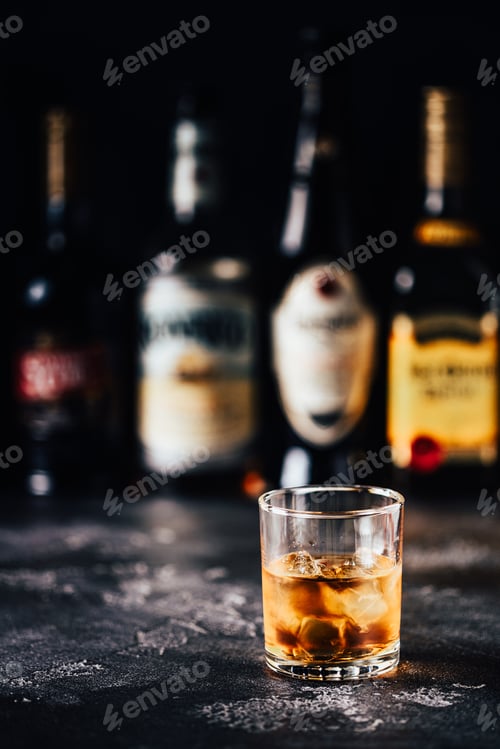 Preview: Whiskey with ice on a dark table