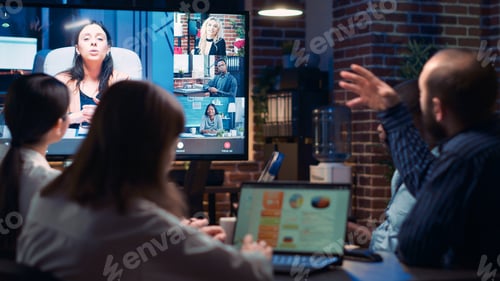 Preview: Employees talking with remote team in videoconference