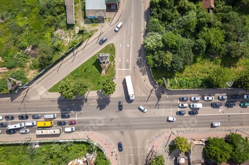 Preview: Top down aerial view of busy street intersection with moving cars traffic.