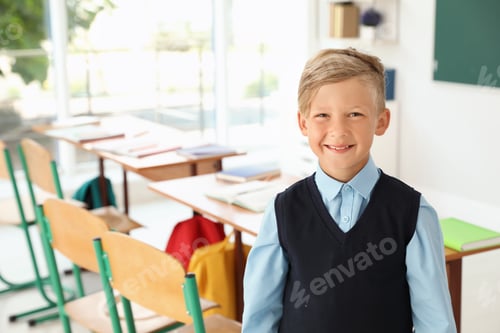 Preview: Little boy in classroom. Stylish school uniform