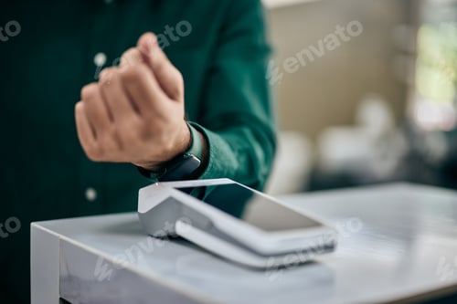 Preview: Close-up of a male paying the bill over the smartwatch.