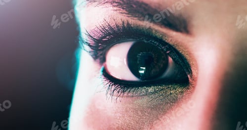Preview: Closeup portrait of a beautiful young womans eye against a dark background