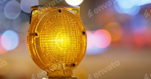 Preview: Yellow caution light in the street at night