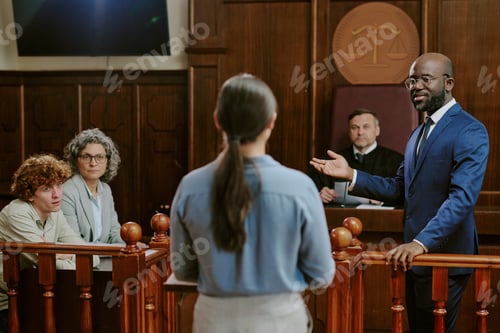 Preview: Black Middle Aged Man Questioning Young Adult Woman Witness in Courtroom