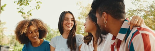 Preview: Group of friends talking and laughing merrily in city park