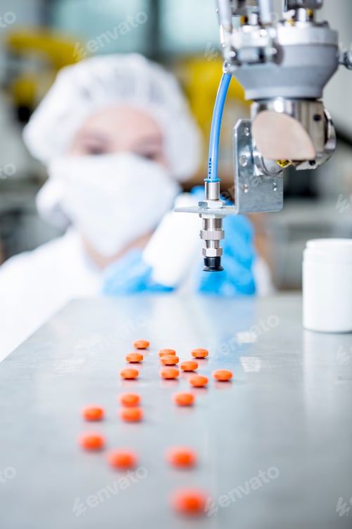 Preview: Robot handling tablets with woman in background