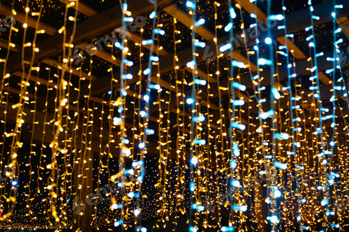 Preview: Hanging string lights in golden and blue colors create a magical atmosphere at night